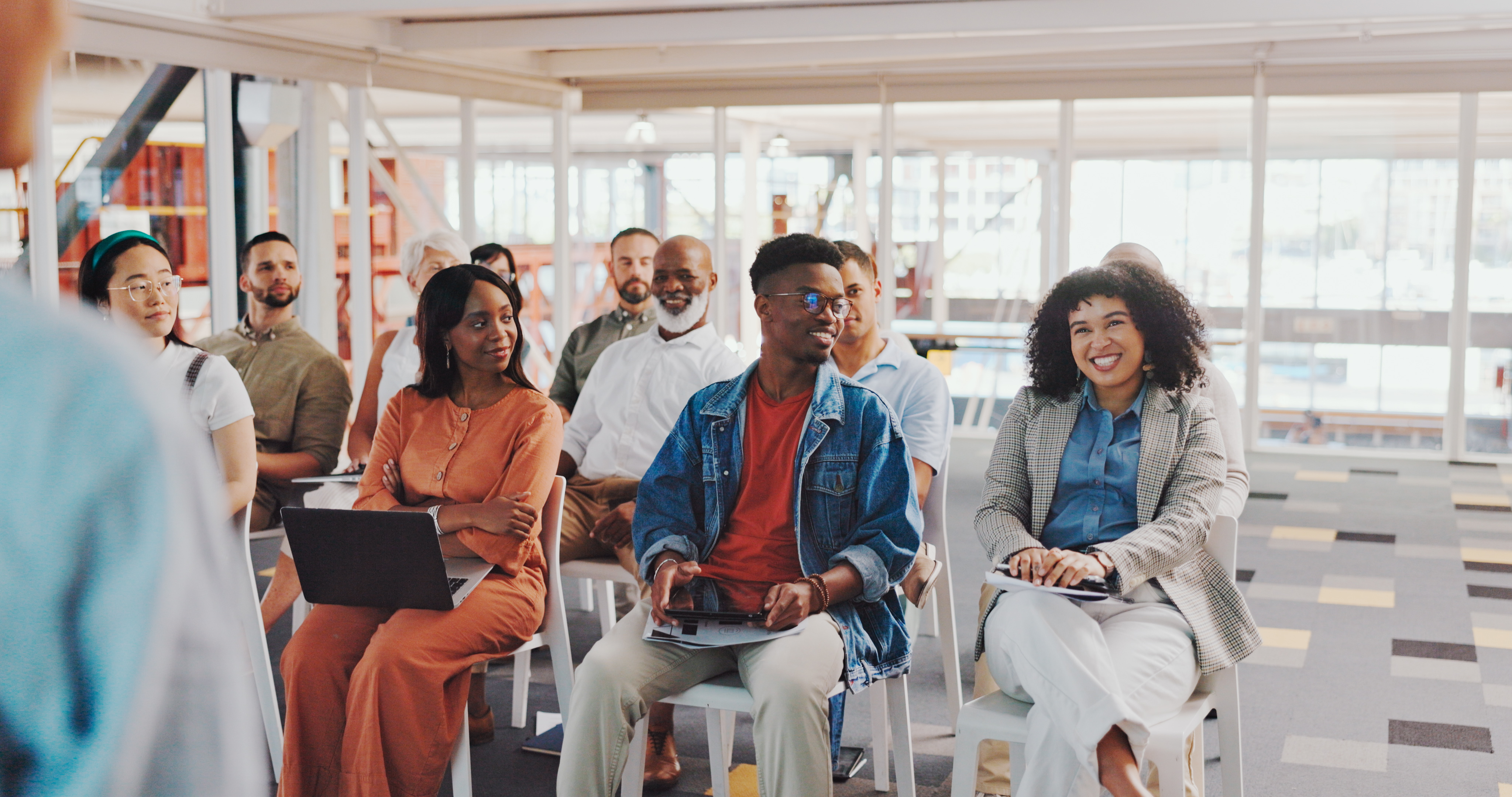 Business people, happy woman and group attention to speaker presentation speech, tradeshow or seminar. Convention, conference meeting or professional audience leaning, strategy or listen to presenter
